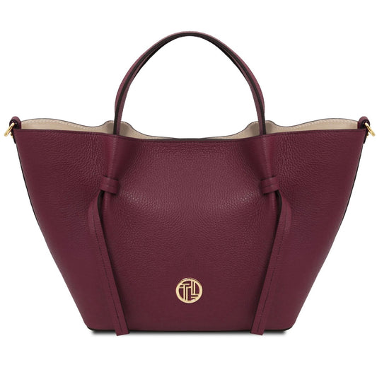 Maroon handbag with a gold logo on a white background