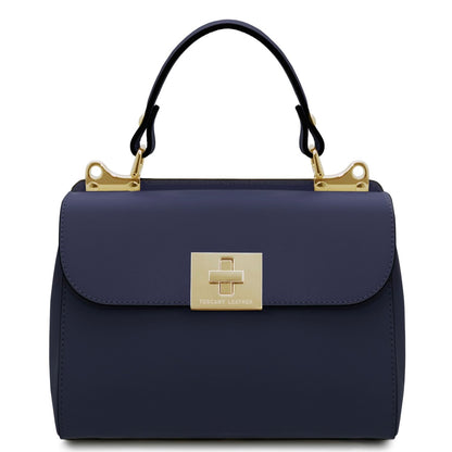 Navy handbag with gold clasp and handle on a white background