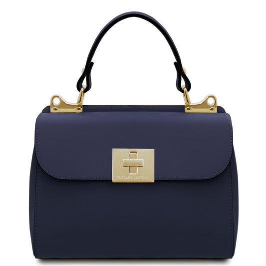 Navy handbag with gold clasp and handle on a white background