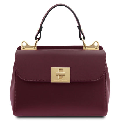 Maroon handbag with gold accents on a white background